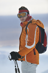 Image showing young skier relaxing at beautiful sunny winter day