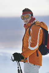 Image showing young skier relaxing at beautiful sunny winter day