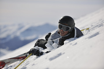 Image showing young skier relaxing at beautiful sunny winter day