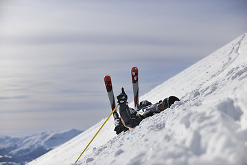 Image showing young skier relaxing at beautiful sunny winter day