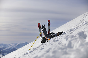 Image showing young skier relaxing at beautiful sunny winter day