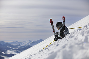 Image showing young skier relaxing at beautiful sunny winter day