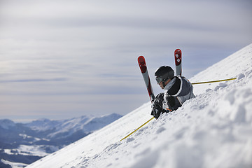 Image showing young skier relaxing at beautiful sunny winter day