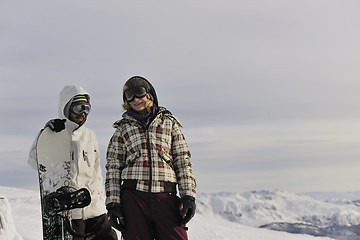 Image showing snowboarder's couple on mountain's top