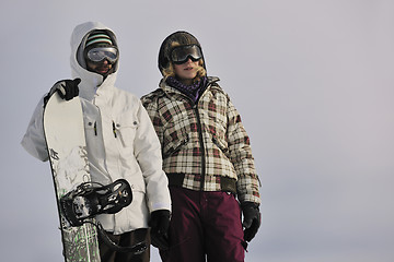 Image showing snowboarder's couple on mountain's top