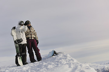 Image showing snowboarder's couple on mountain's top