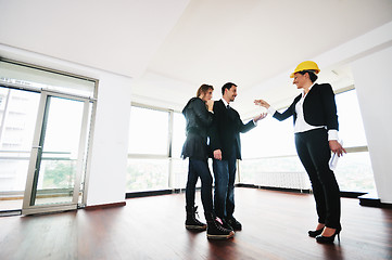 Image showing happy young couple buying new home with real estate agent