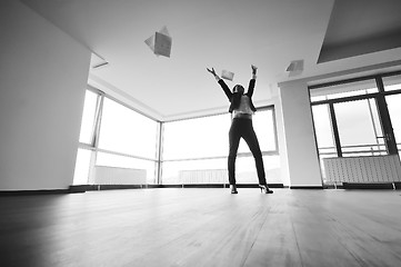 Image showing young business woman throw papers in air