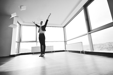 Image showing young business woman throw papers in air