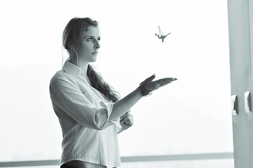 Image showing young woman throwing home keys in air