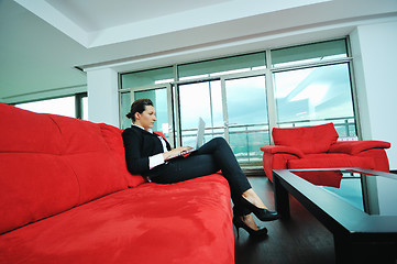 Image showing young business woman working on laptop at home