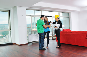 Image showing happy young couple buying new home with real estate agent