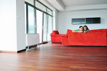 Image showing happy couple relax on red sofa 