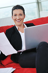 Image showing young business woman working on laptop at home