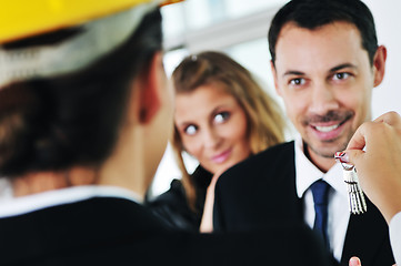 Image showing happy young couple buying new home with real estate agent