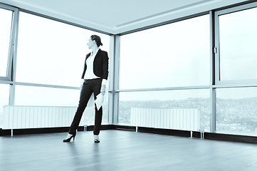 Image showing young business woman throw papers in air