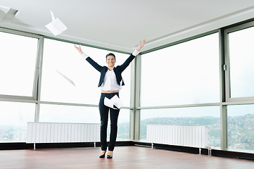 Image showing young business woman throw papers in air