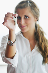 Image showing young woman throwing home keys in air