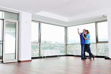 Image showing happy couple in empty apartment