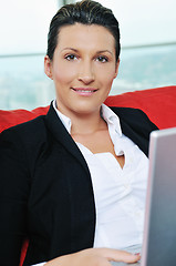 Image showing oung business woman working on laptop at home