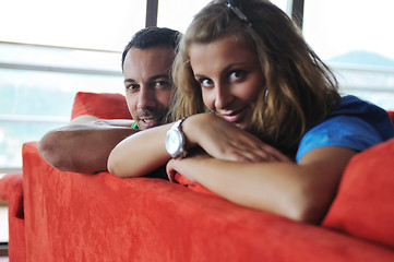 Image showing happy couple relax on red sofa