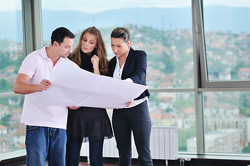 Image showing happy young couple buying new home with real estate agent