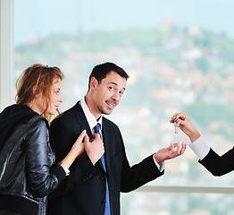 Image showing happy young couple buying new home with real estate agent