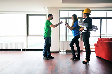 Image showing happy young couple buying new home with real estate agent