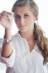 Image showing young woman throwing home keys in air