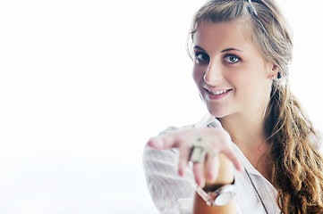 Image showing young woman throwing home keys in air