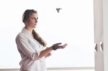 Image showing young woman throwing home keys in air