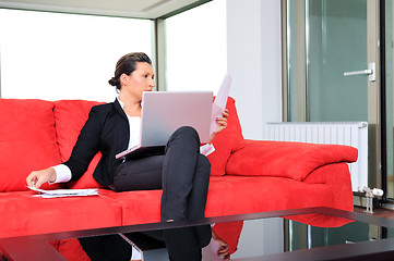 Image showing young business woman working on laptop at home