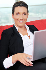 Image showing young business woman working on laptop at home