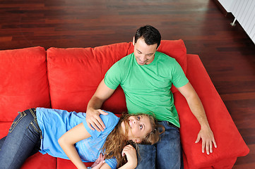 Image showing happy couple relax on red sofa