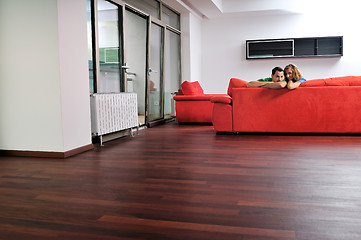 Image showing happy couple relax on red sofa