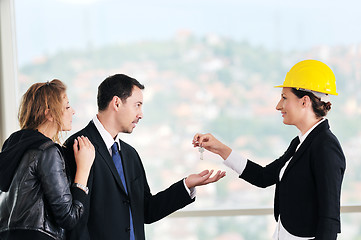 Image showing happy young couple buying new home with real estate agent