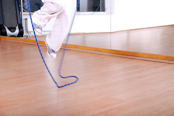 Image showing .young man using a jump rope