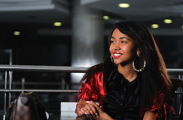 Image showing business woman in red dress smilling