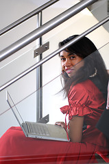 Image showing business woman with laptop on staircase