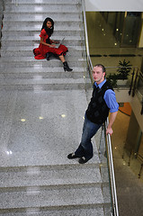 Image showing young business man standing on stairs and hold laptop