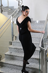 Image showing lady on black dress look back