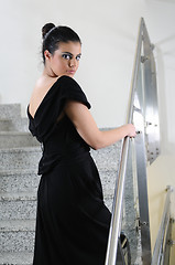 Image showing lady on black dress look back