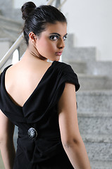 Image showing lady on black dress look back