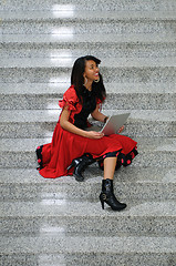 Image showing business woman with laptop on staircase