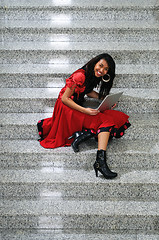 Image showing business woman with laptop on staircase