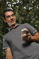 Image showing young casual man talking on cellphone