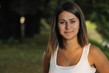 Image showing brunette Cute young woman smiling outdoors in nature