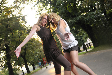 Image showing two girls together outside in dancing position ready for party