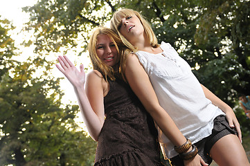 Image showing two girls together outside in dancing position ready for party