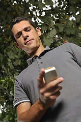 Image showing young casual man talking on cellphone